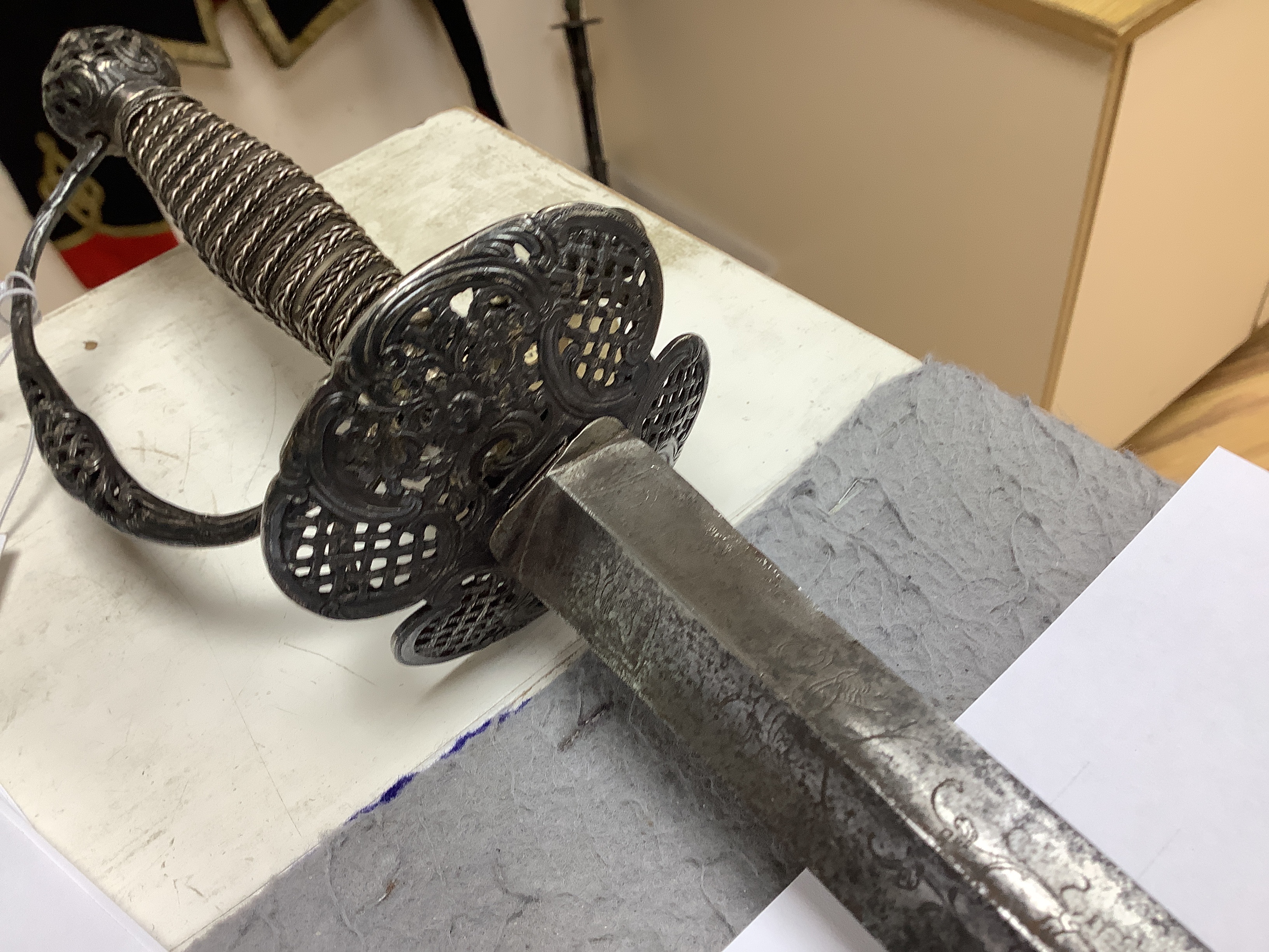 A French silver hilted small sword, c.1770, the ricasso rings have two tiny marks struck on the end which possibly could be Paris discharge marks, the hilt pierced with basketweave decoration and flowers, silver wire and